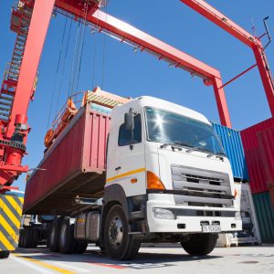 shipping-container-being-moved-by-red-crane-2026-03-26-08-17-05-utc