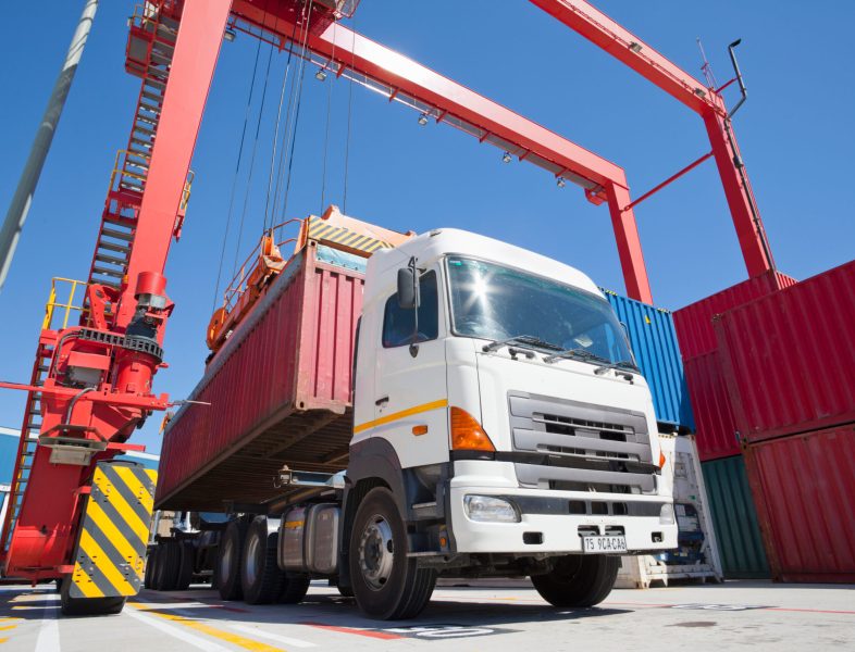 shipping-container-being-moved-by-red-crane-2026-03-26-08-17-05-utc